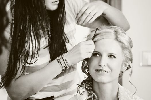 hair stylist designer making hairstyle for woman bride in wedding day black and white tone