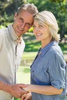 Portrait of happy couple head to head in park