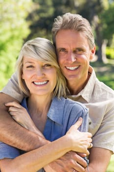 Portrait of smiling couple embracing in park