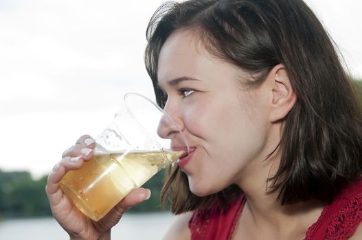 young woman drinking glas of beer