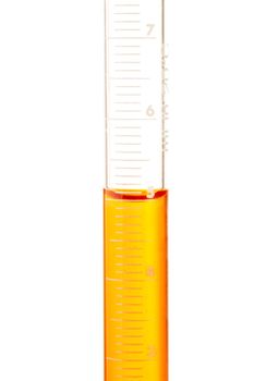 Measuring 5 ml of orange liquid in glass pipette