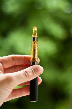 e-cigarette with hand closeup in outdoor