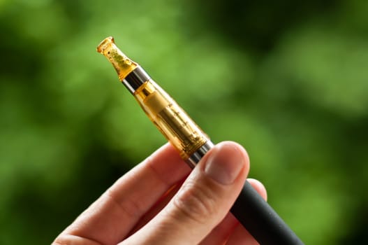 e-cigarette with hand closeup in outdoor