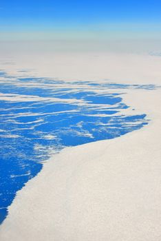 An aerial view of the frozen landscape of Greenland