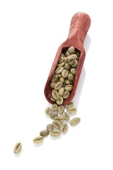 Green coffee beans on wooden scoop isolated on white background. Weight loss dietary supplement. 