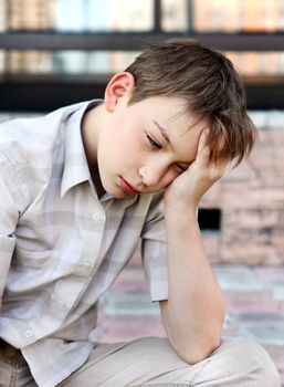 Sad and Troubled Kid sitting outdoor