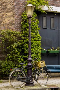 Bicycle tied on a light pole in Amsterdam