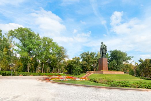 Taras Shevchenko monument in Shevchenko park, Kyiv, Ukraine under blue sky