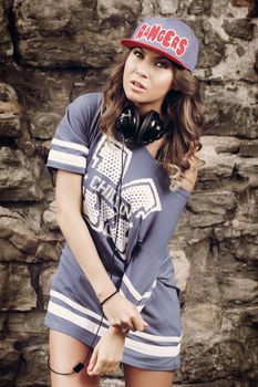 Outdoor, street. Attractive girl in the cap