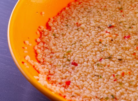 Cous cous in close up in a yellow plate