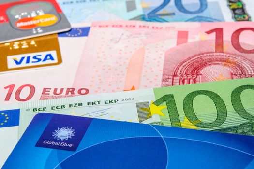 MUNICH, GERMANY - FEBRUARY 23, 2014: Global Blue, Visa and MasterCard credit cards on Euro banknotes