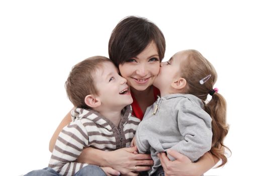 Happy mother hugging two children over white