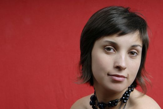 young woman portrait isolated on red background