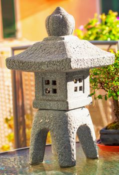 Small decorative stone temple with candle inside