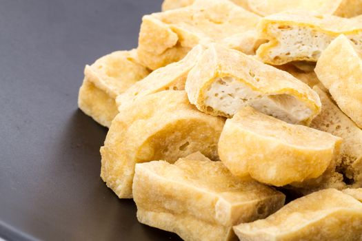 deep fried tofu on black dish