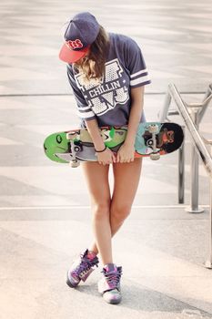 Outdoor, street. Attractive girl at the skatepark
