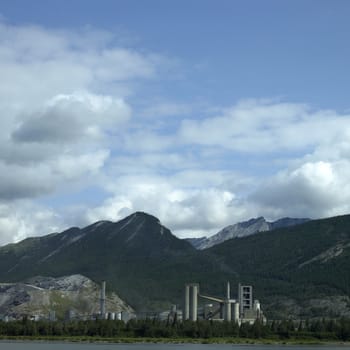 Large factory at the foot of the mountains