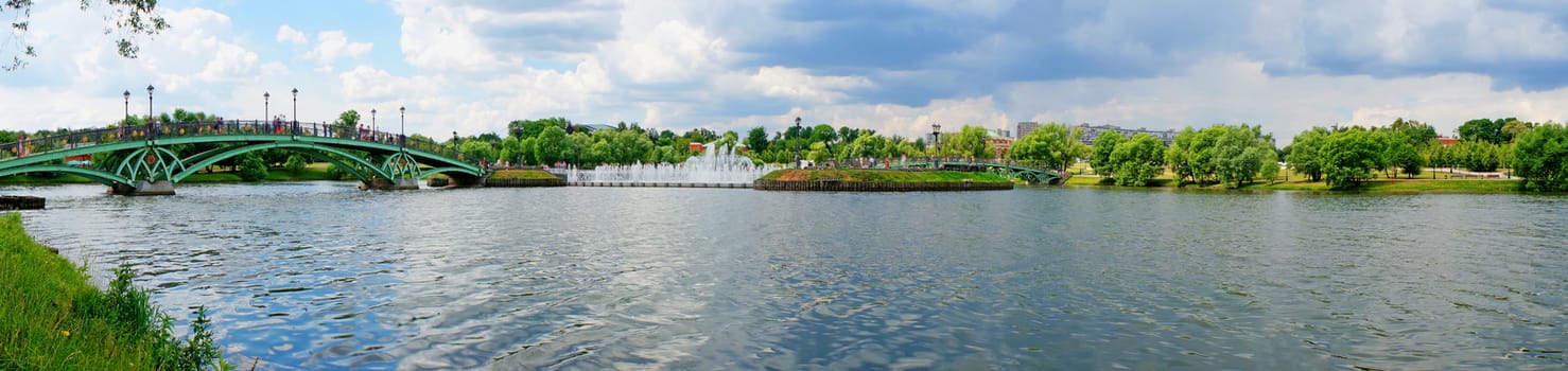 Summer Panorama: bridge over the river and fountain                               