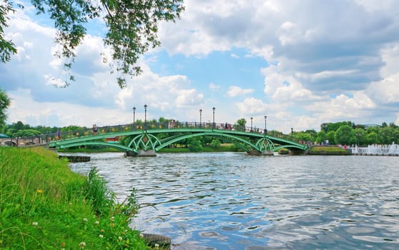 Summer landscape: a bridge across the lake and fountain                              