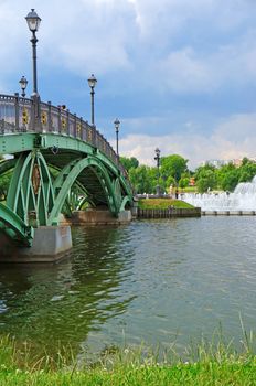 Summer landscape: a bridge across the lake                               