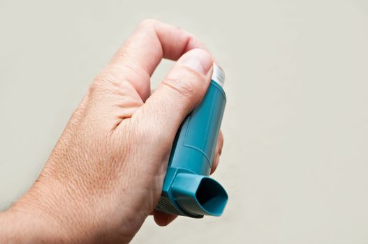 hand with asthma aerosol closeup