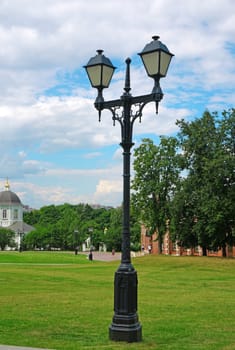 Old forged lantern in a summer park                               