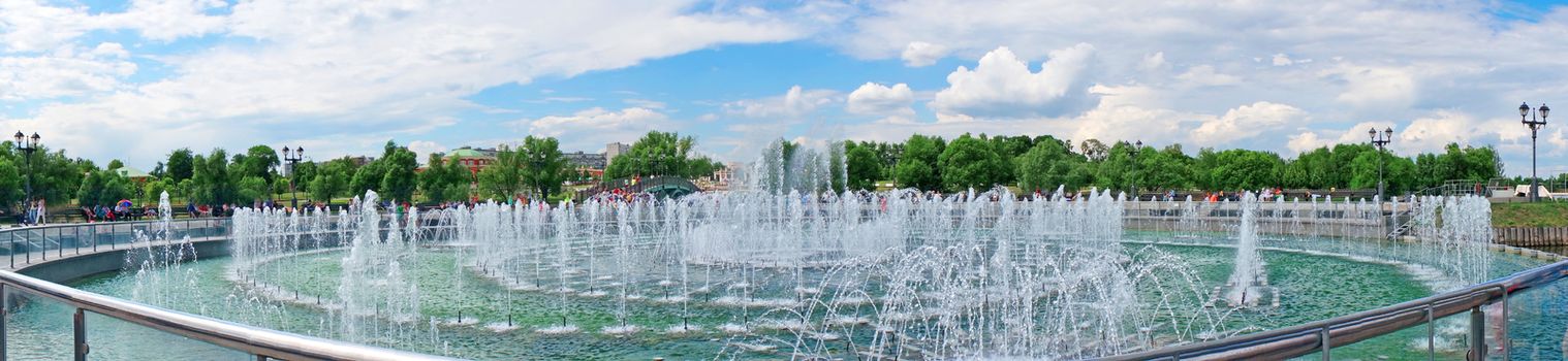 Panorama beautiful fountain against the blue sky with clouds