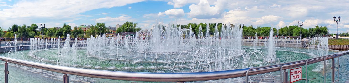 Panorama beautiful fountain against the blue sky with clouds