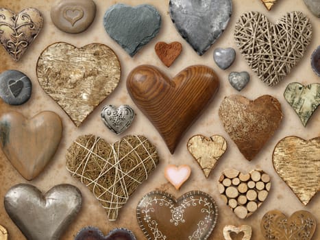 Background of heart-shaped things made of stone, metal and wood.
