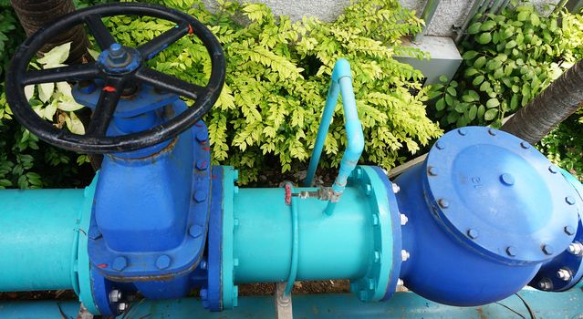 Water pipelines used in industrial factories. A large blue pipes with valves for control.                               