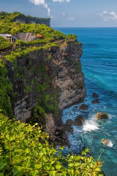 Surf waves and turqoise water along the coast of Bali