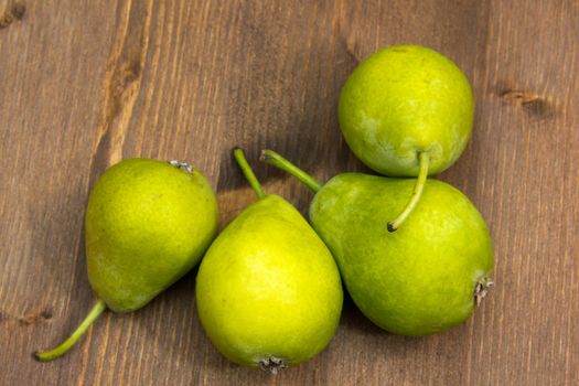 Small pears on wooden table