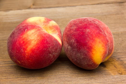 Fresh peaches on wooden table