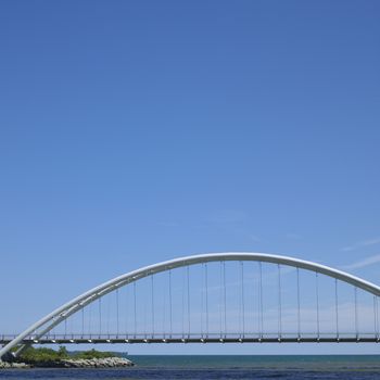Modern white bridge over lake