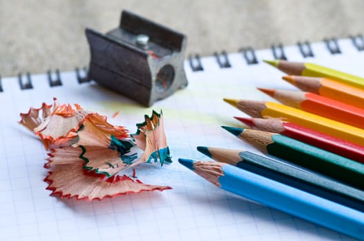 school supplies pencils colors on the beach