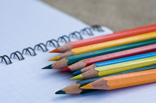 school supplies pencils colors on the beach