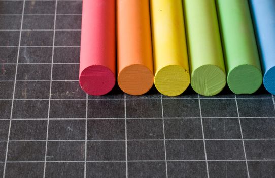 school supplies - chalks on chalkbord closeup