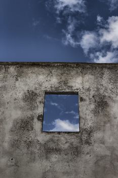 Square window on old ruined wall on the roof of Doxi Stracca Fontana Palace about 1760 A.D. in the old town of Gallipoli (Le)) in the southern Italy