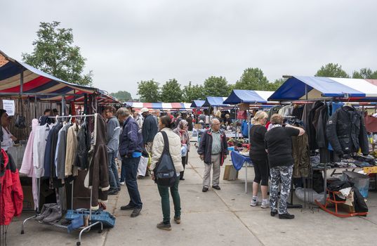 HELLEVOETSLUIS,NETHERLANDS-JULY 12, 2014: People shopping on the anual farmers market in Hellvoetsluis on July12,this market is only once a year and selling clothes and fresh food