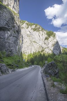 Curved road and vertical rock walls in Bicaz Gorges, Romania