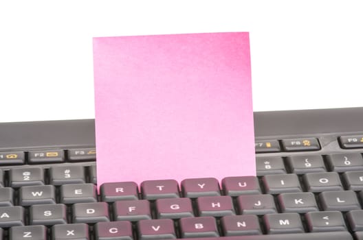 Blank paper note on a black keyboard.