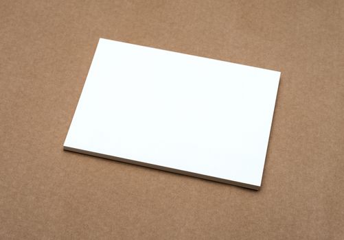 Stack of blank white business cards on crafts background