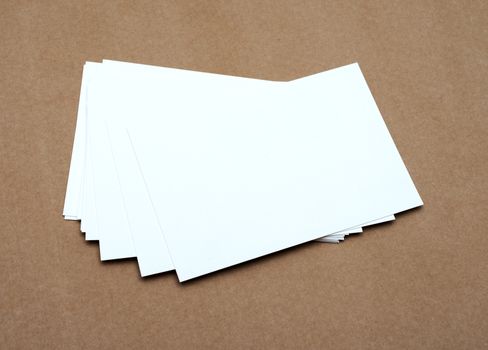 Stack of blank white business cards on crafts background