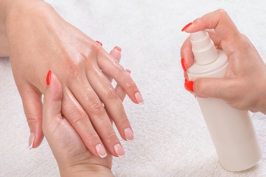 beauty salon, manicure applying, moisturising with thermal water