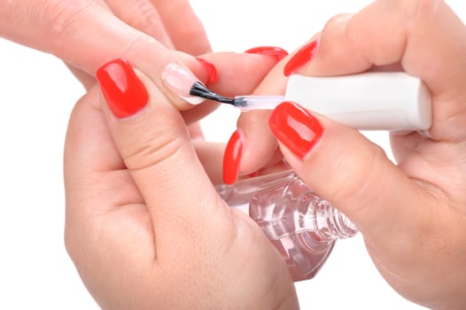 manicure applying, brushing fingernails with clear enamel