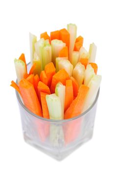 Slices of fresh green celeryand carrot in glass isolated on white