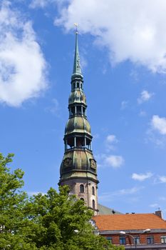 The steeple of the magnificent St. Peter's Church towering over the Old Town in Riga, Latvia.