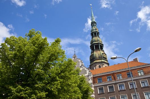 The steeple of the magnificent St. Peter's Church towering over the Old Town in Riga, Latvia.