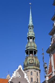 The steeple of the magnificent St. Peter's Church towering over the Old Town in Riga, Latvia.