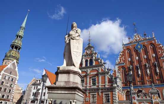 The historic House of the Blackheads, St. Peter's Church and statue of Saint Roland in the old town of Riga in Latvia.